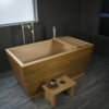 Hybrid Teak and Hinoki Ofuro Tub with Tray and Stool. Installed with Tub Filler and Sonoma Forge Remote Tub Drain & Overflow